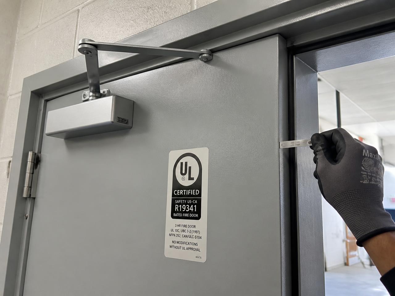 Fire-rated door and operating hardware being inspected